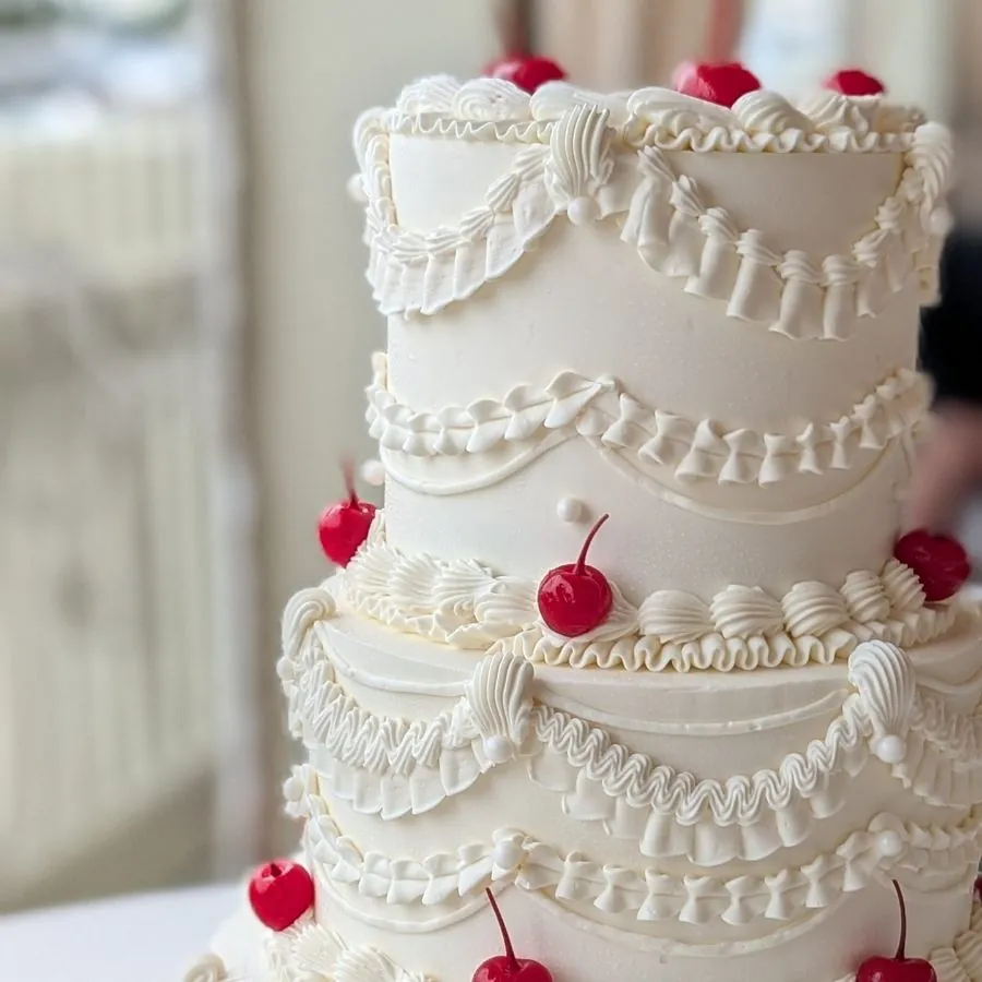 Detail of piped garlands and cherries on a wedding cake