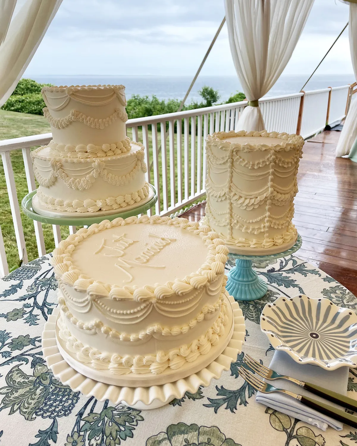 Vintage piped wedding cakes on an oceanside porch